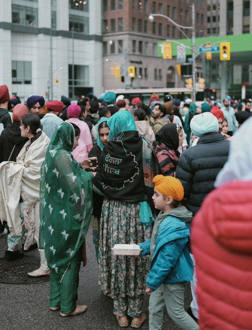 a group of people standing on the side of a road