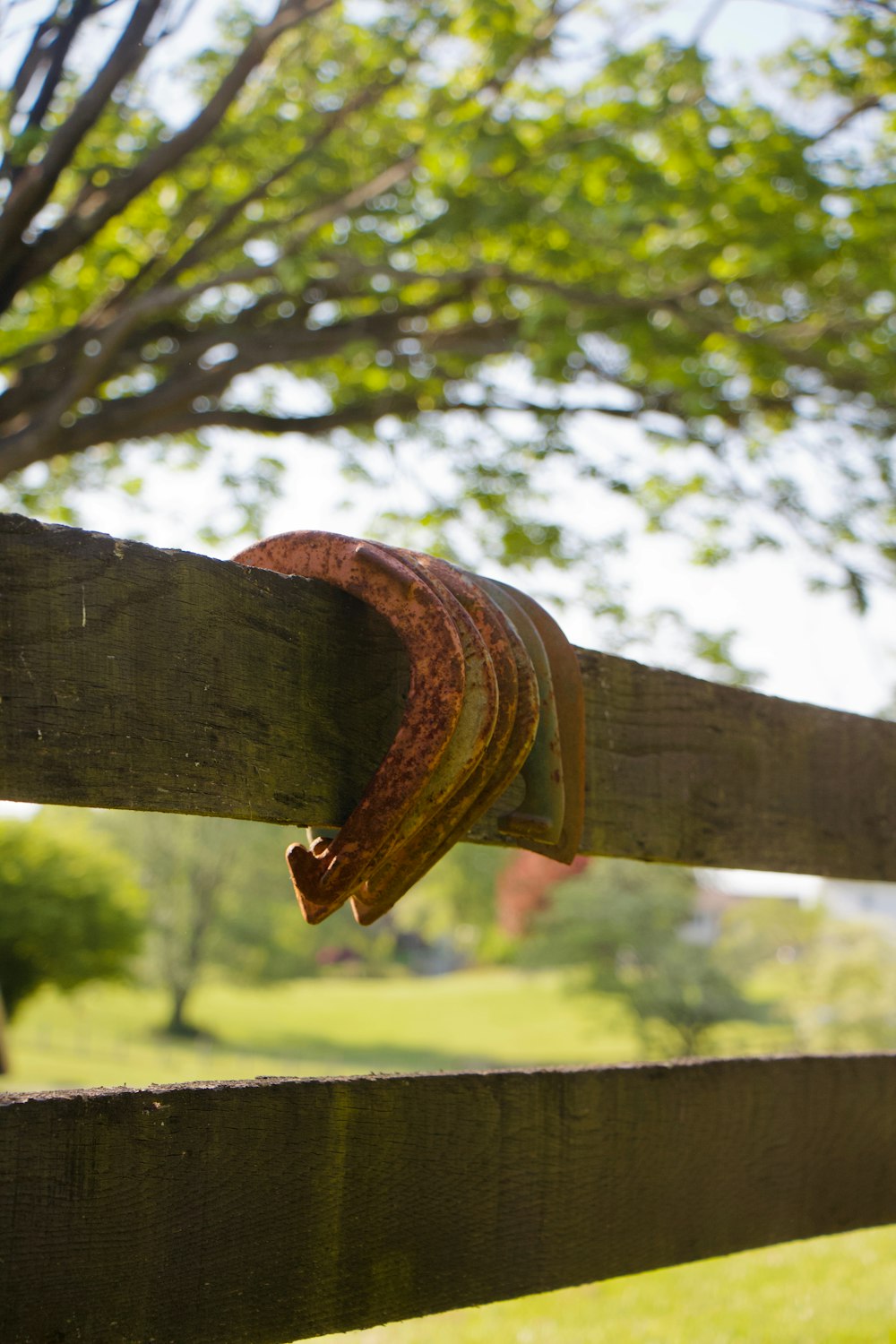 a wooden fence with a rusted hat on top of it