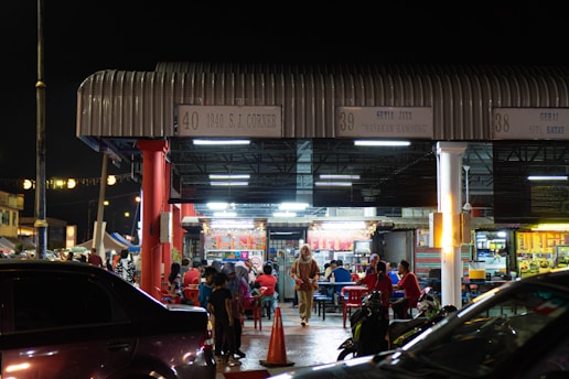 a group of people standing outside of a building at night
