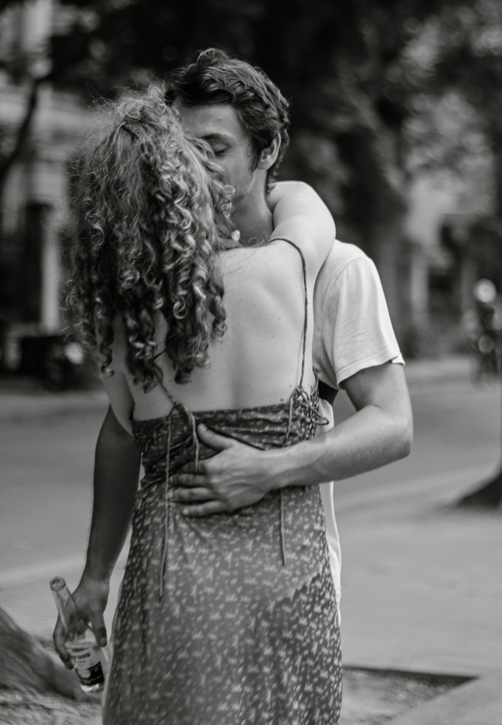 a man and a woman kissing on the street