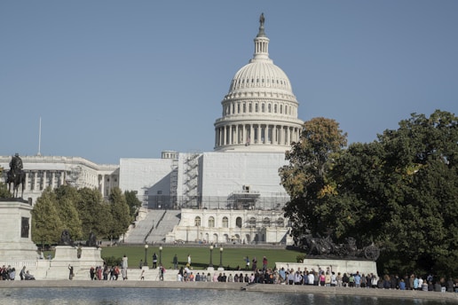 a group of people standing in front of the capitol building