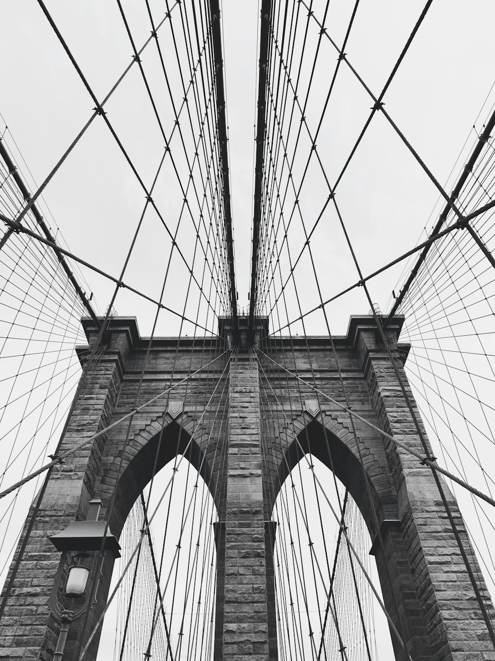 a black and white photo of the brooklyn bridge