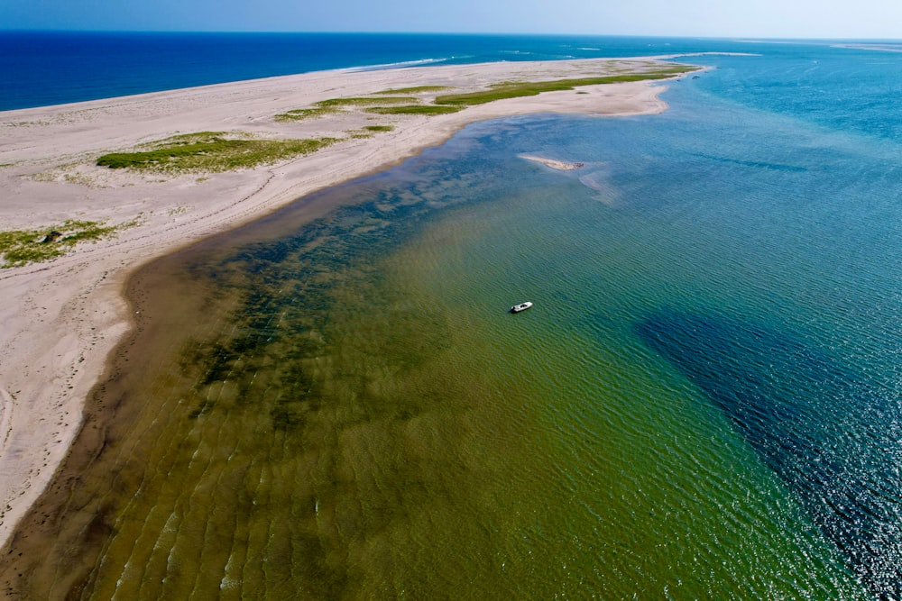 an aerial view of a body of water with a boat in it