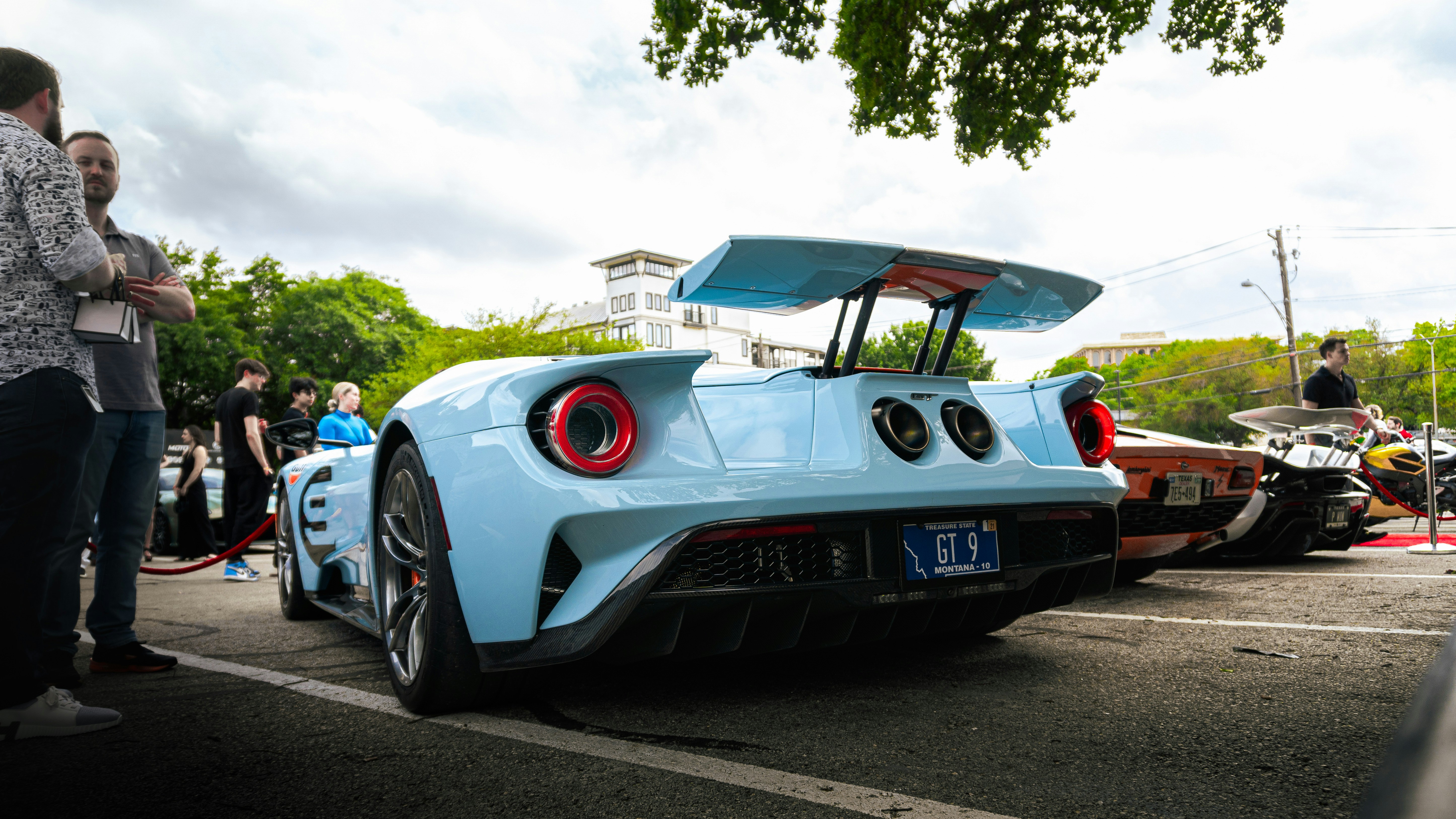 a blue sports car parked in a parking lot