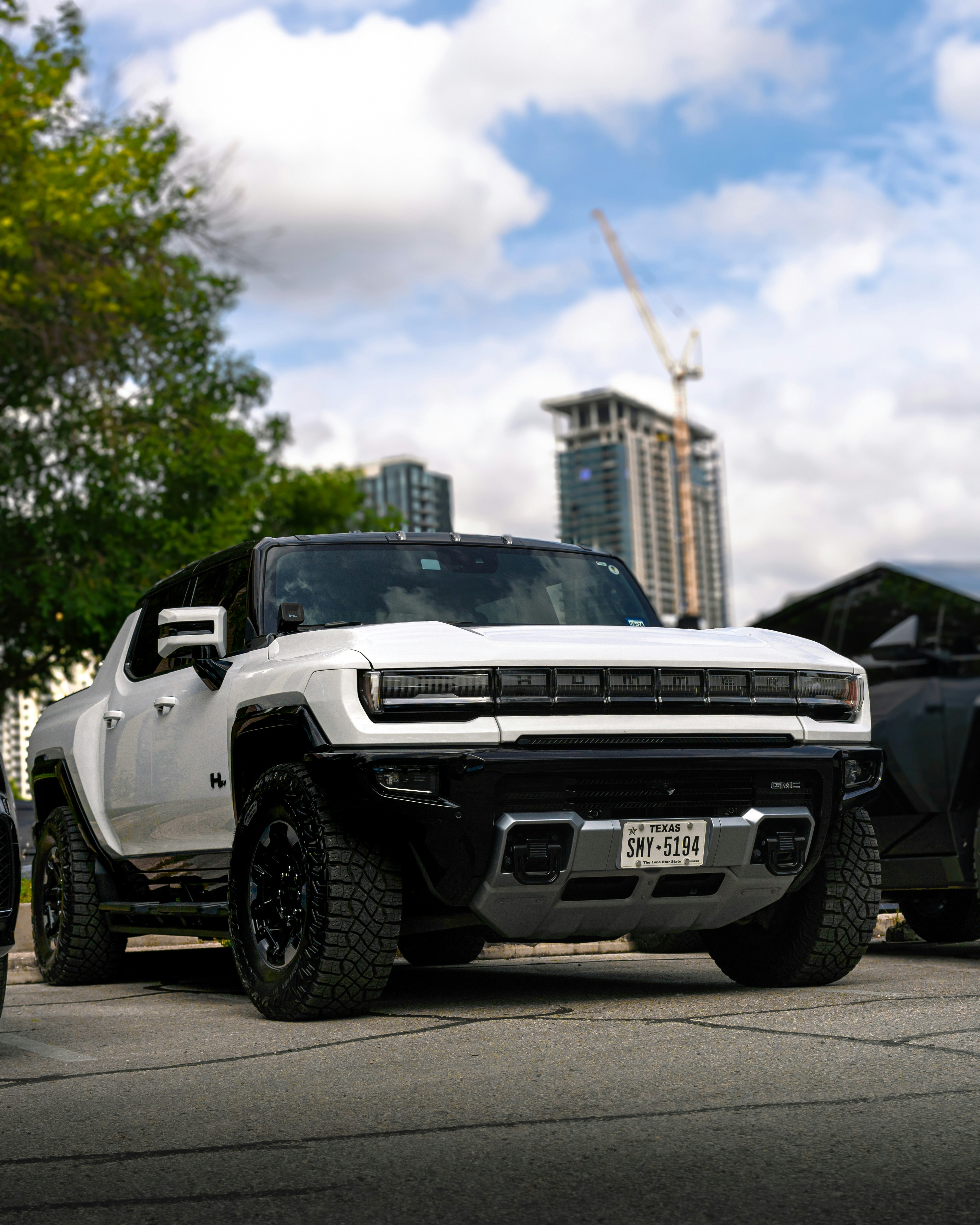 a white pickup truck parked next to a black pickup truck