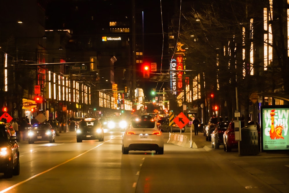 a city street filled with traffic at night