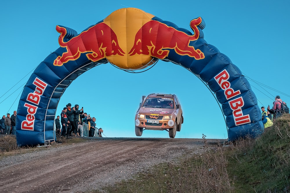 a red bull rally car going through an arch