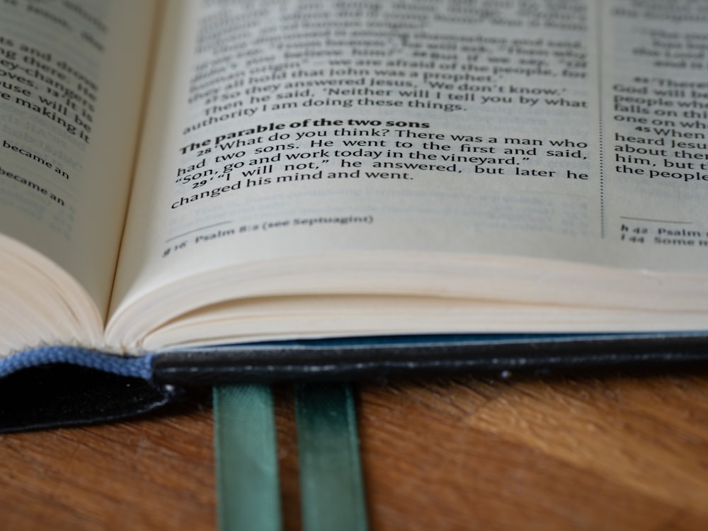 an open book sitting on top of a wooden table