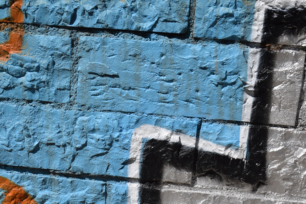 a close up of a blue and white brick wall