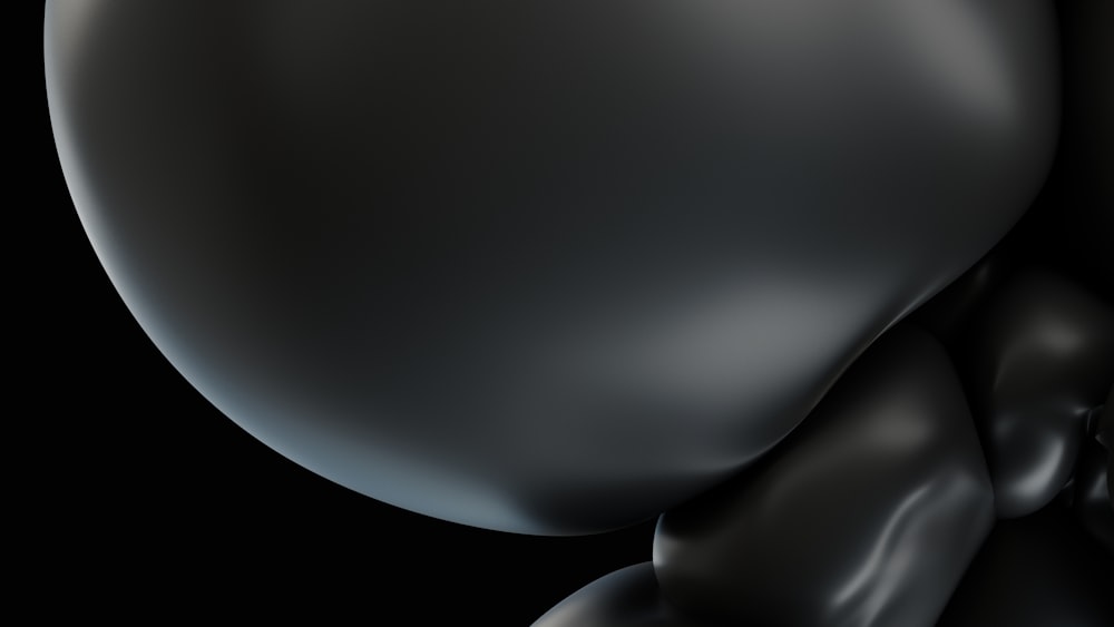 a close up of a black object on a black background