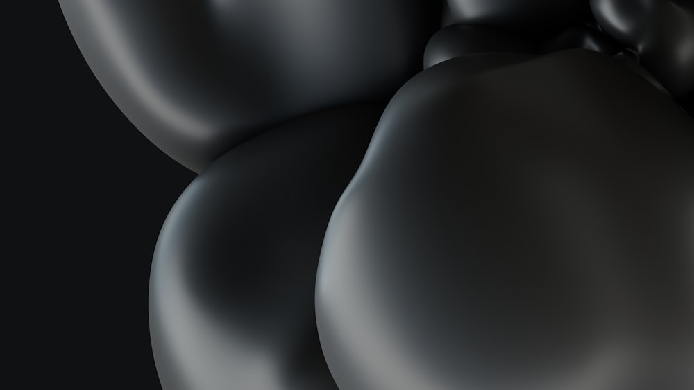 ein schwarzer Hintergrund mit einem Haufen Luftballons