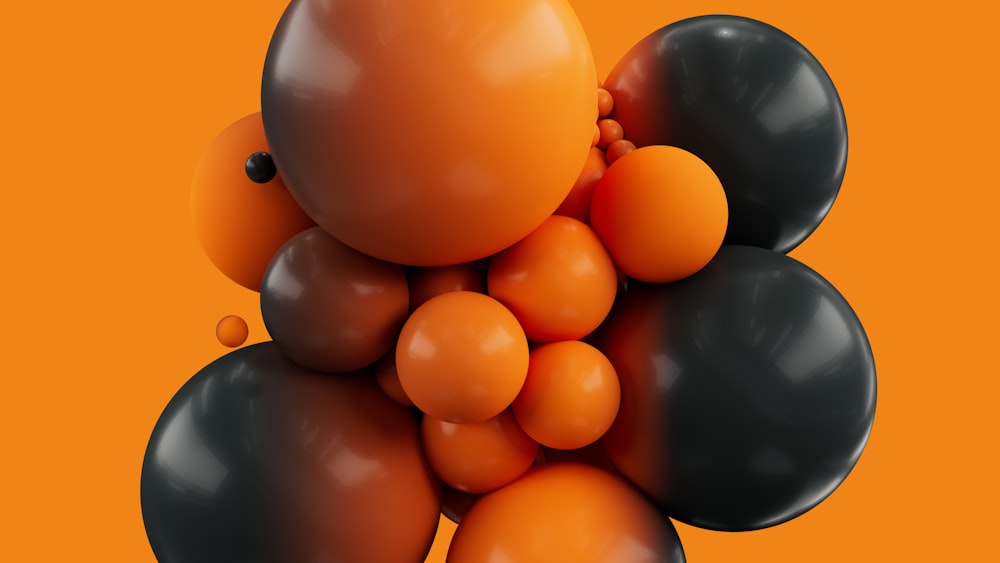 ein Haufen schwarzer und orangefarbener Luftballons auf orangefarbenem Hintergrund