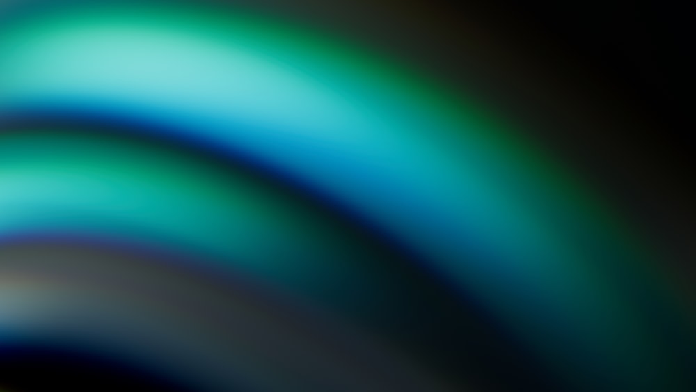 a blurry image of blue and green colors