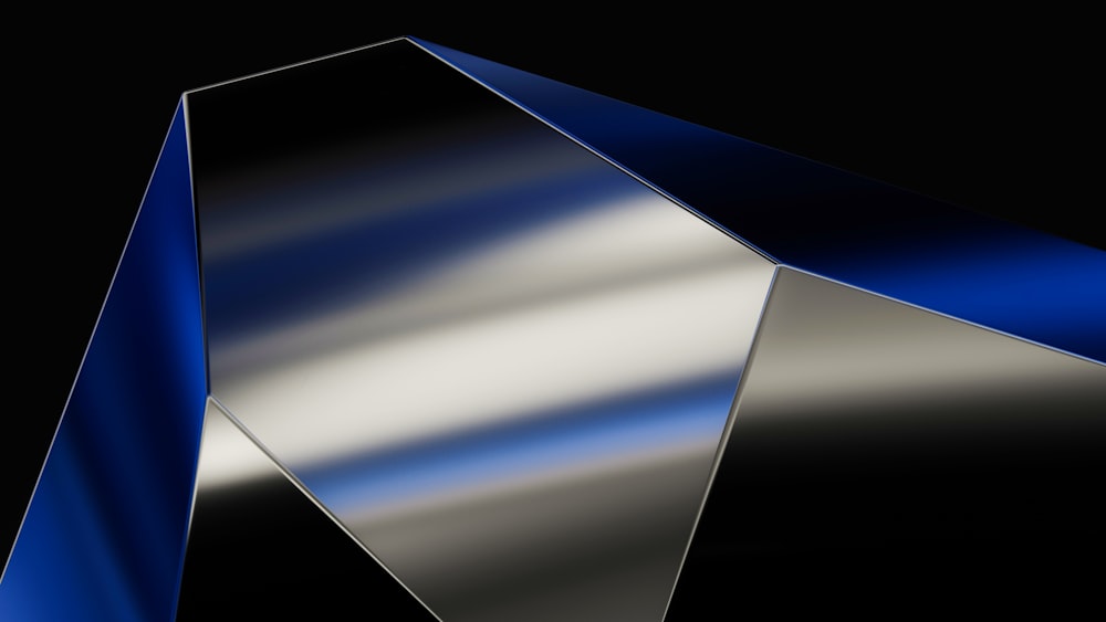 a shiny metal object on a black background