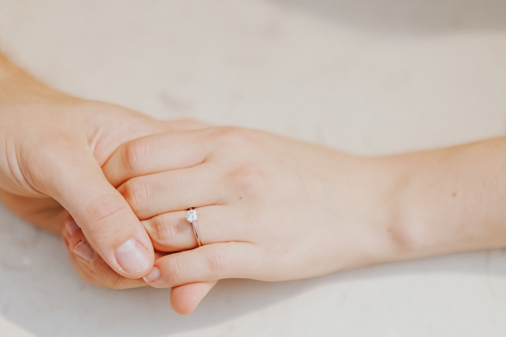 a close up of a person holding the hand of another person