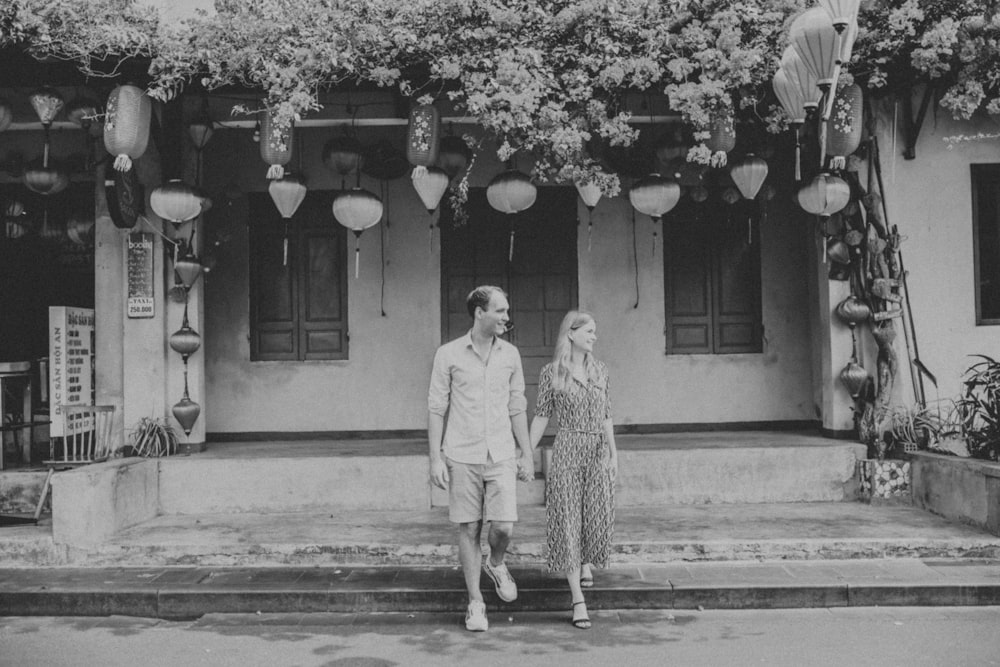 a man and a woman standing in front of a building