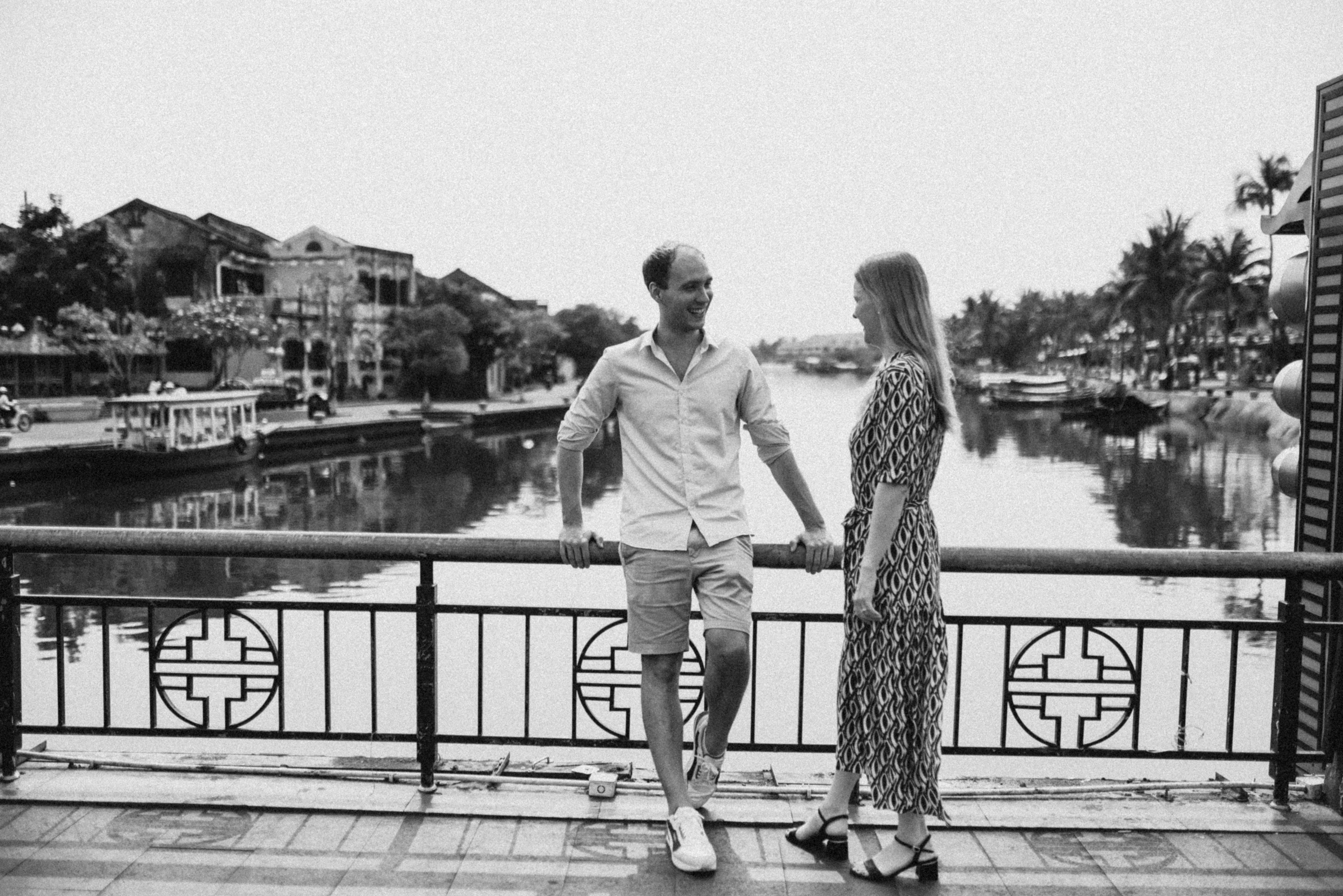 a black and white photo of a man and a woman holding hands