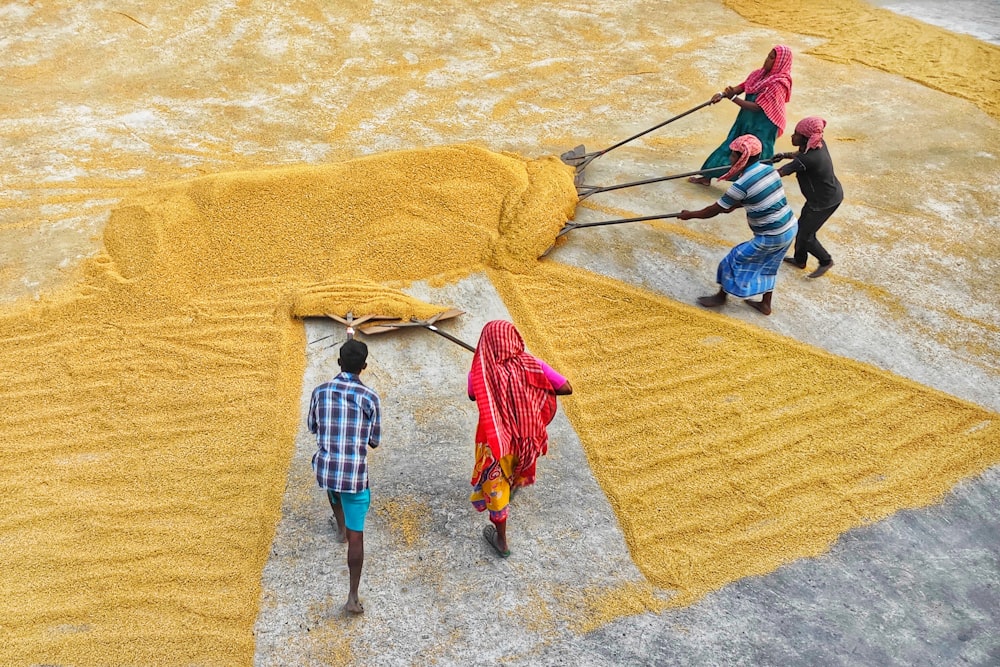 a group of people standing around a pile of dirt