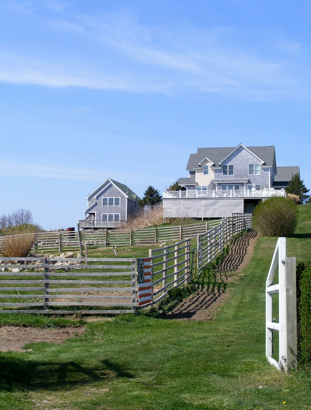 a fenced in field with a house in the background