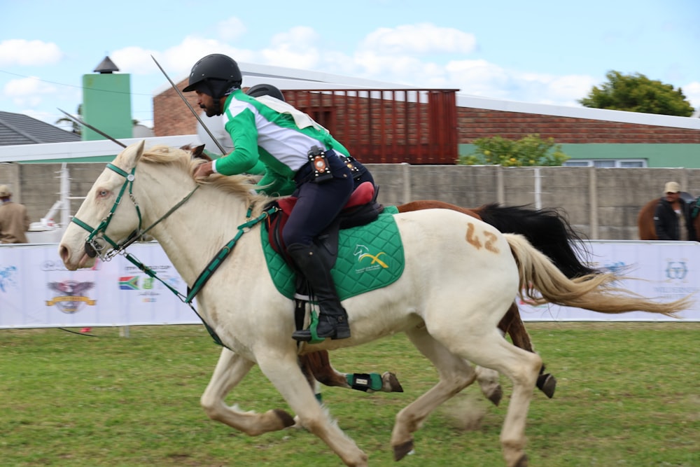 a man riding on the back of a white horse