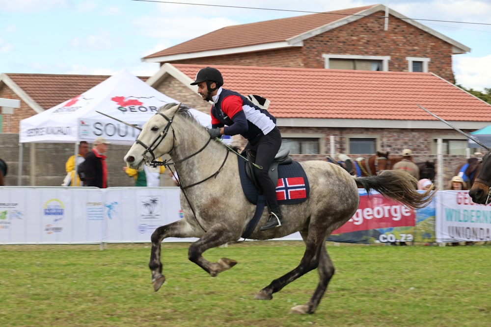 a man riding on the back of a white horse