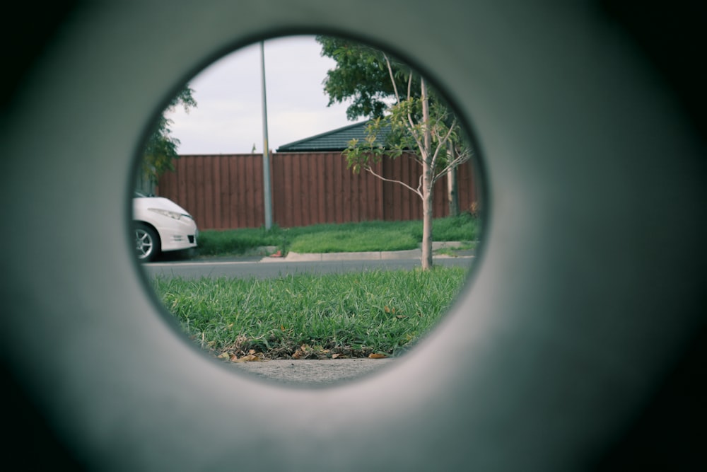 a view of a car through a circular object