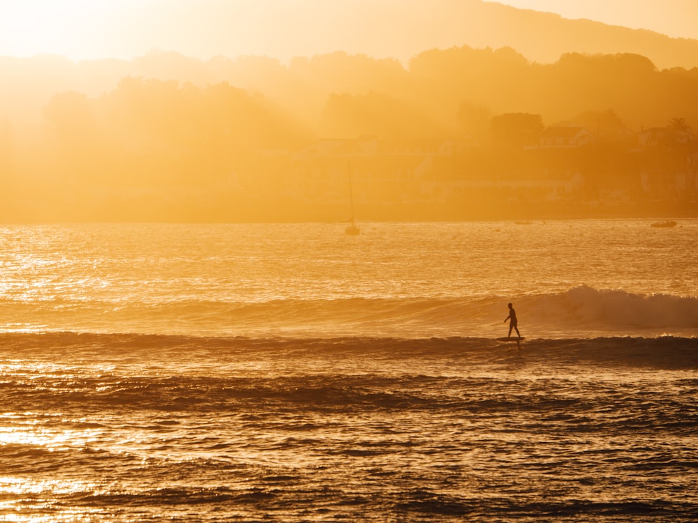 a person riding a surfboard on a wave in the ocean