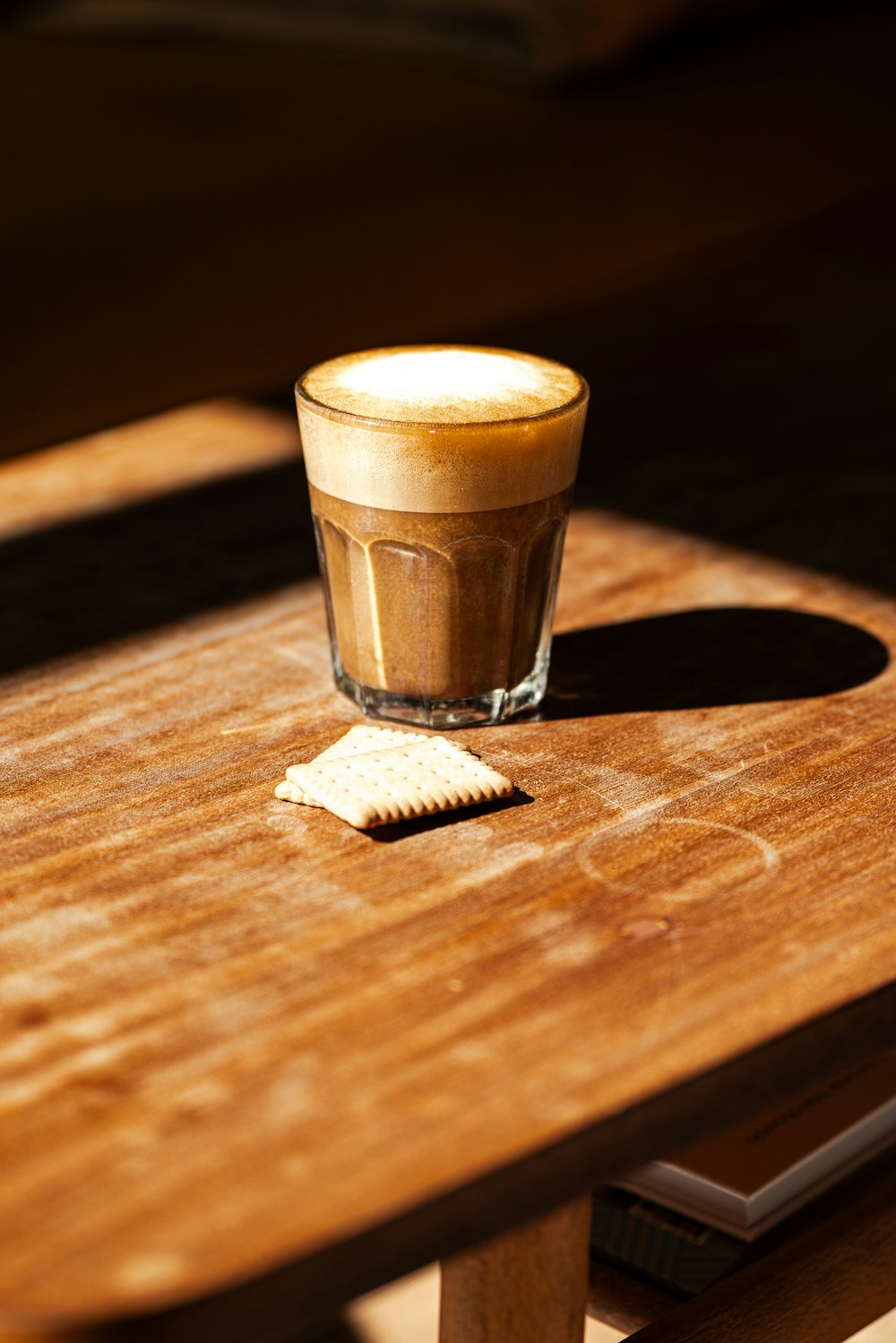 a shot glass sitting on top of a wooden table