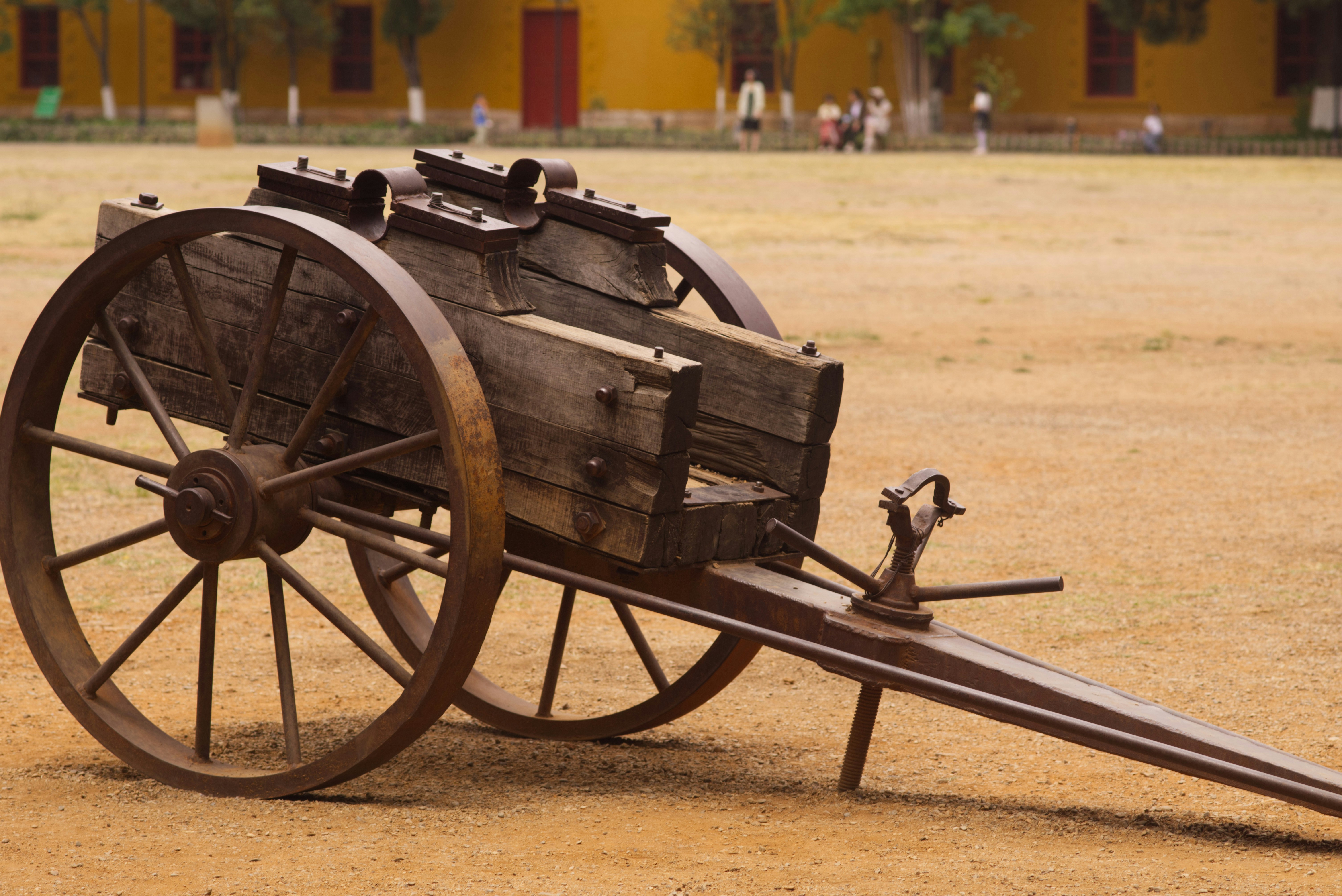 an old wooden cart with a long wooden handle