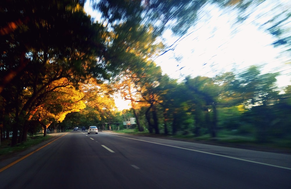 a blurry picture of a car driving down a road