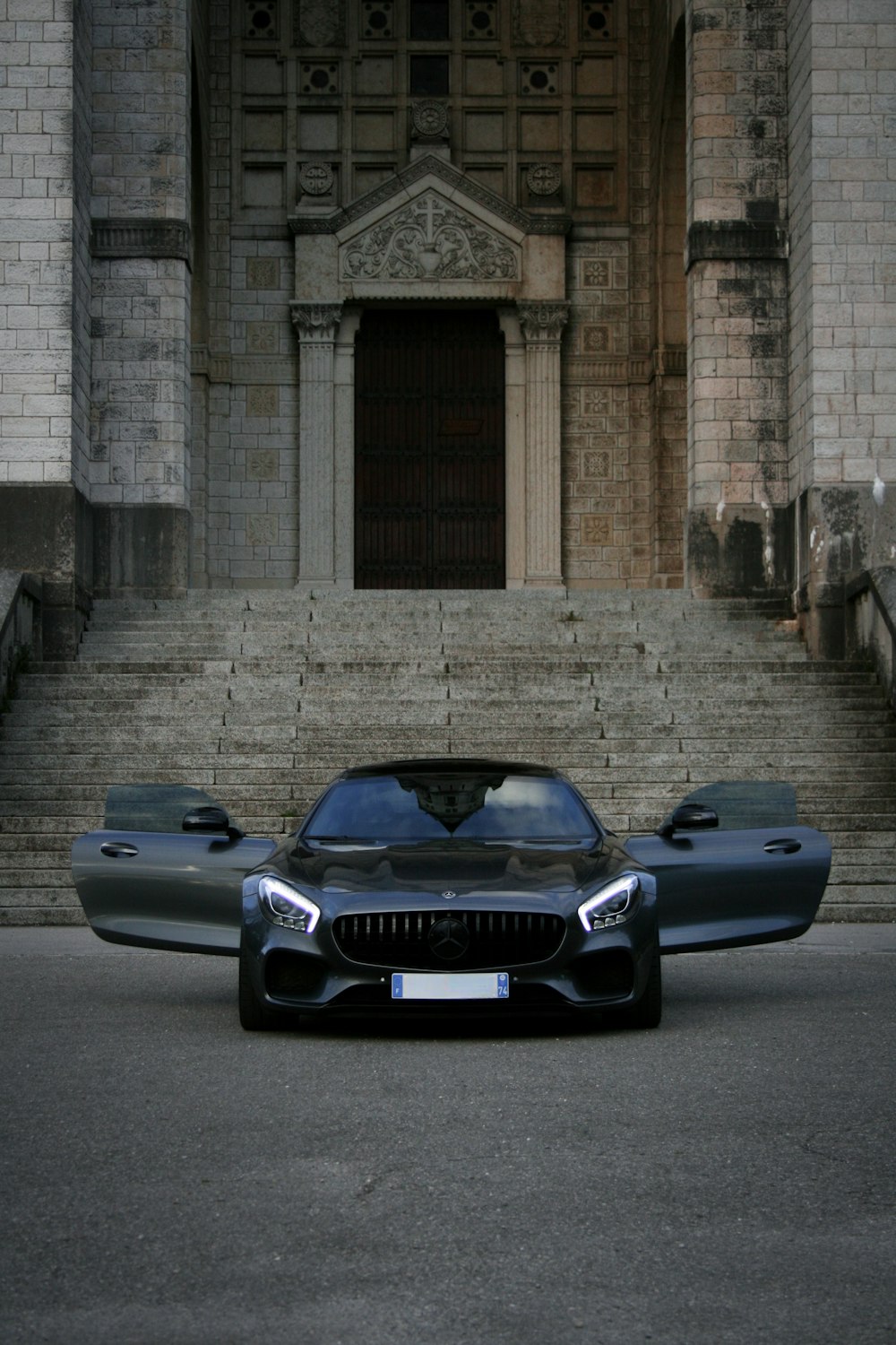 a black sports car parked in front of a building