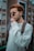 a man in a sweater smoking a cigarette
