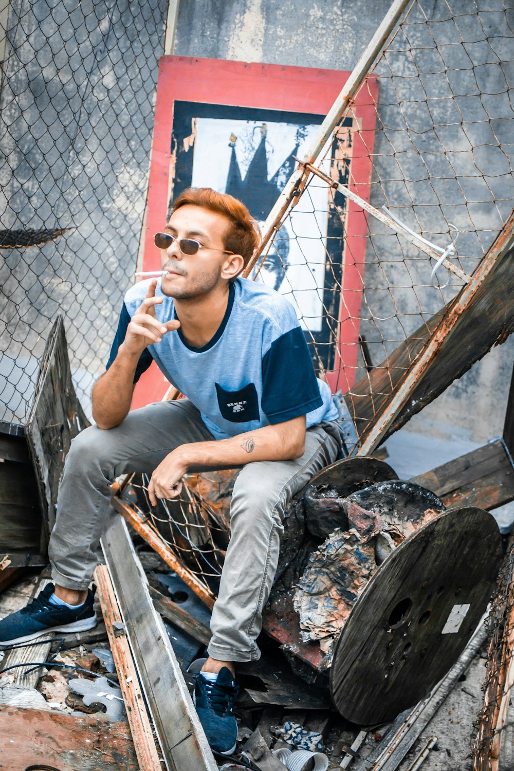 a man sitting on top of a pile of junk