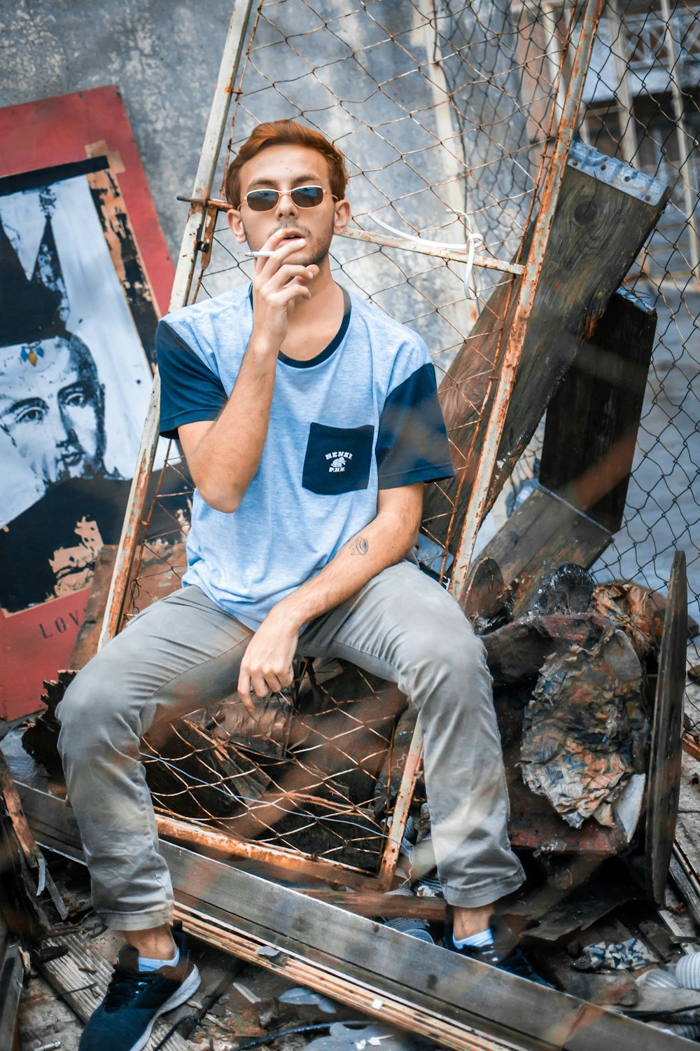 a man sitting on a chair smoking a cigarette