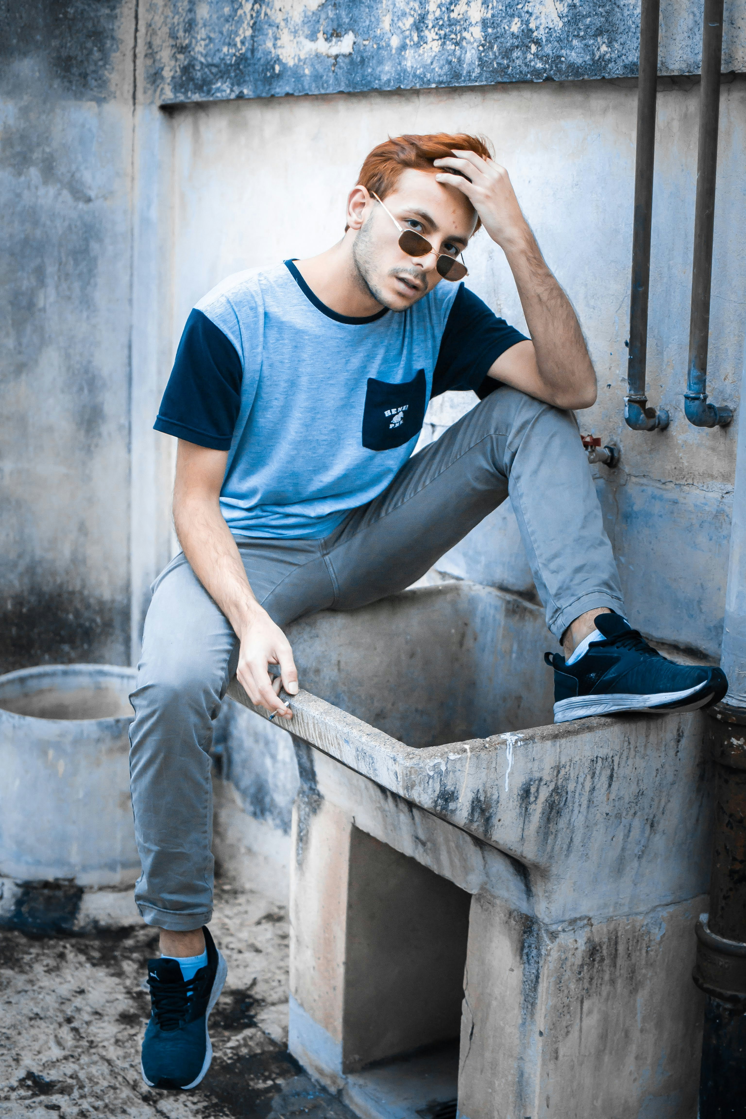 a man sitting on top of a cement box