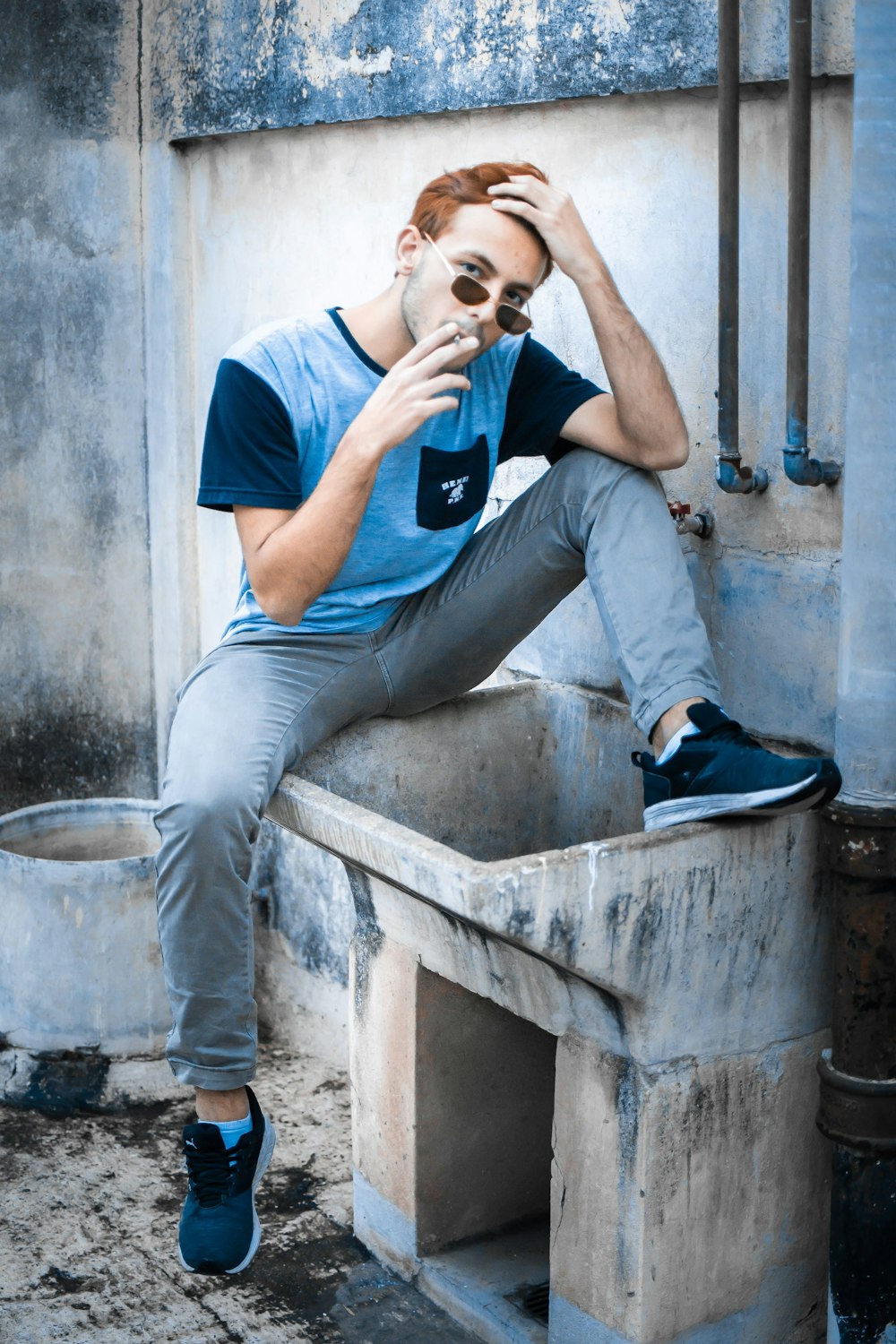 a man sitting on top of a cement structure