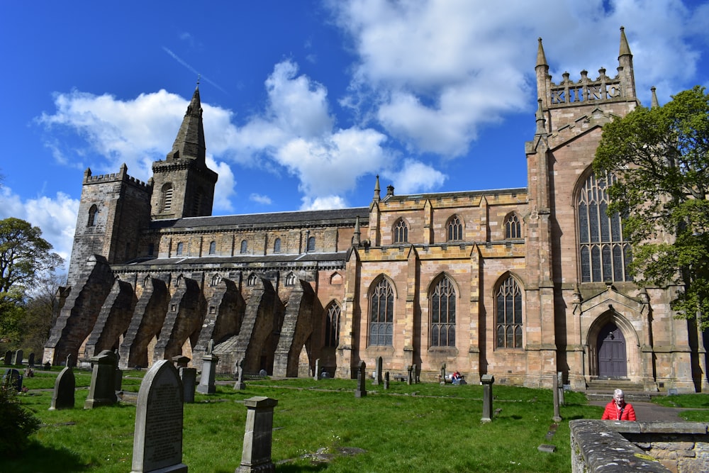 a large church with a tall tower next to a cemetery