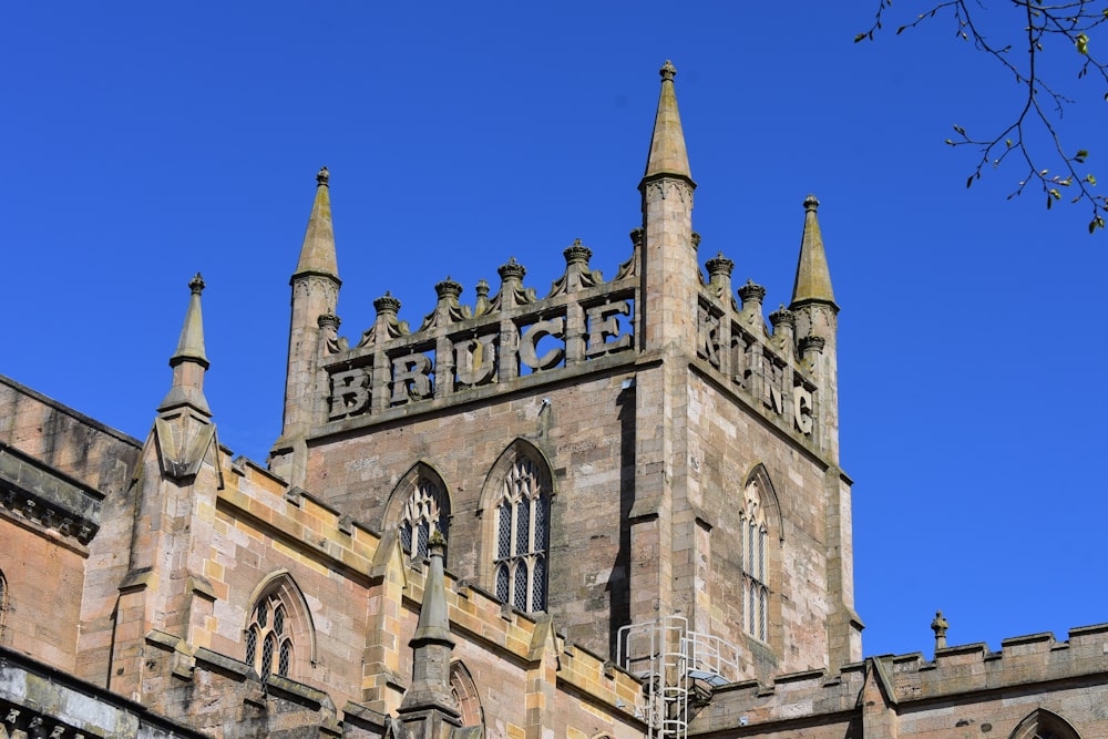 a tall brick building with a clock on it's side