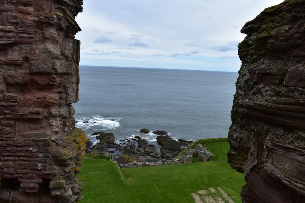 a view of the ocean from inside a castle