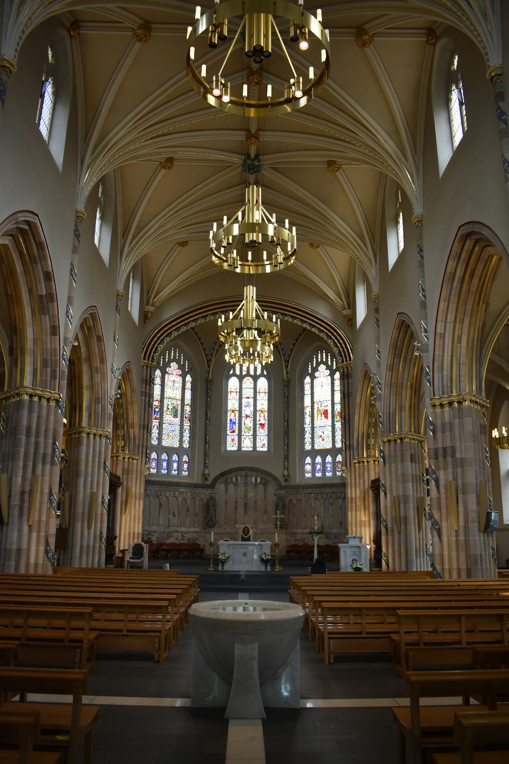 a church with a chandelier and pews