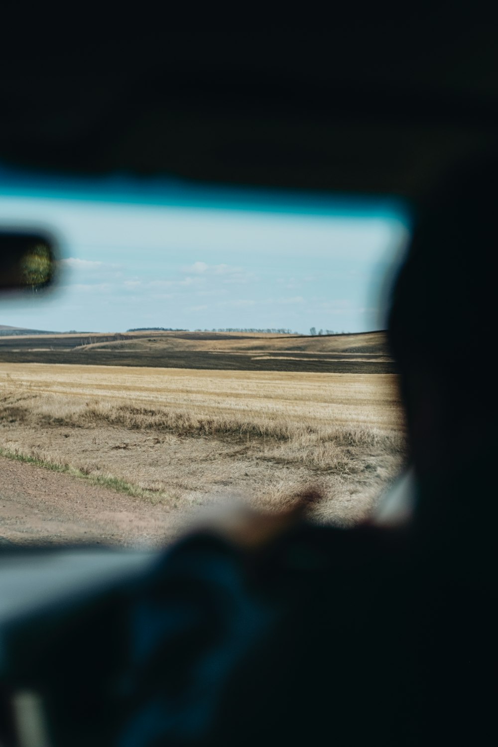 a view from inside a car of an open field