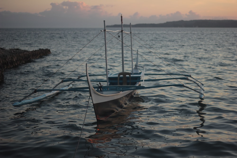 a boat sitting on top of a body of water