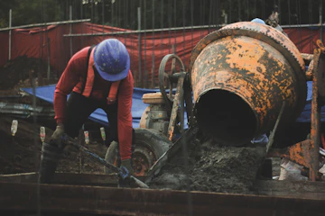 a man in a hard hat working on a pipe