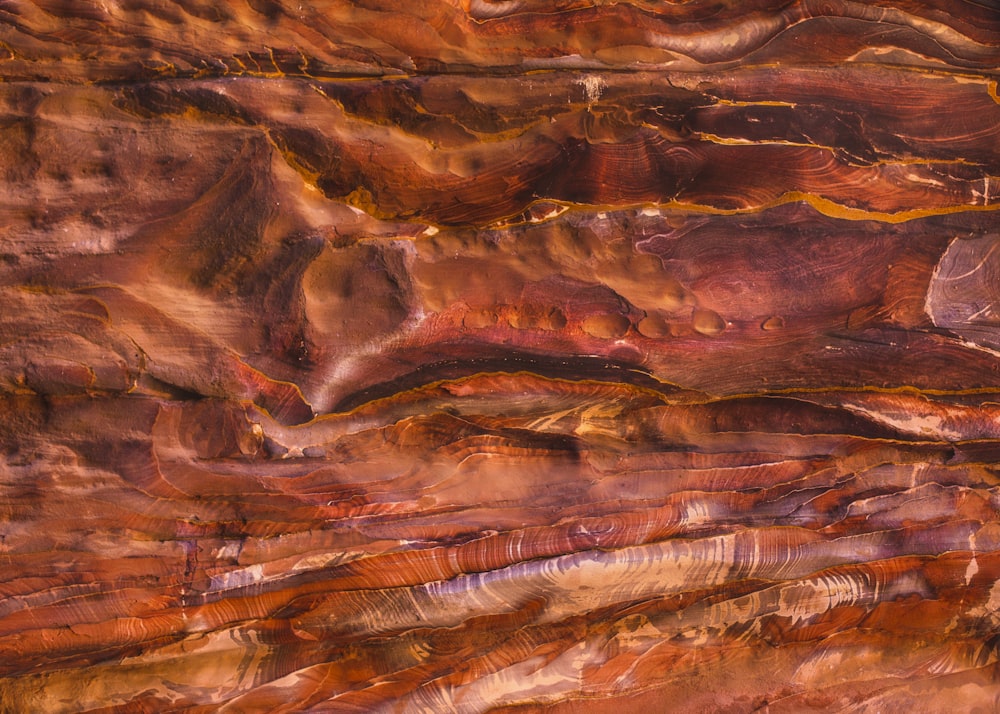 a close up of a rock face with a sky in the background