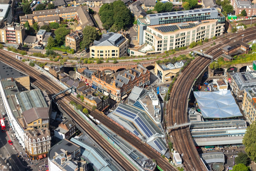 an aerial view of a train station in a city