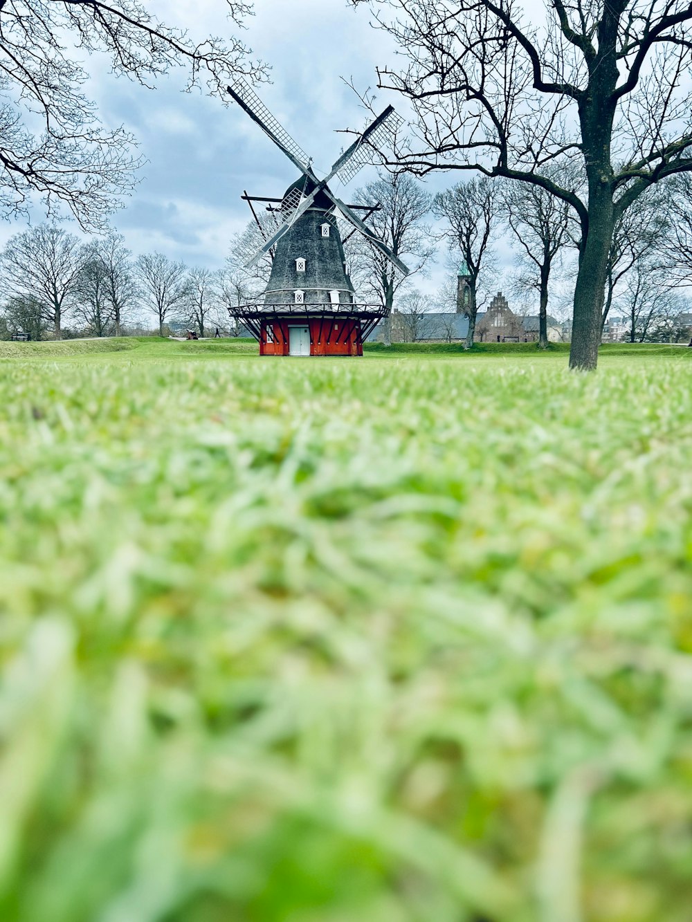 a windmill sitting in the middle of a field