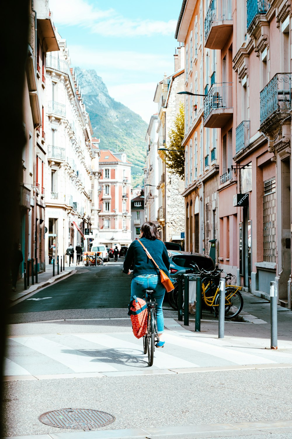 a person riding a bike down a street