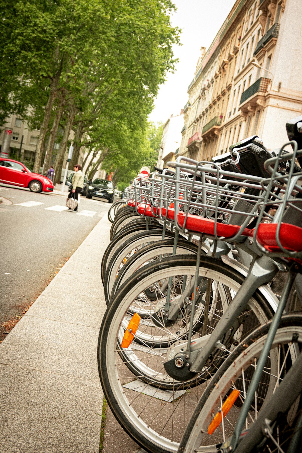 a row of bicycles parked on the side of a street