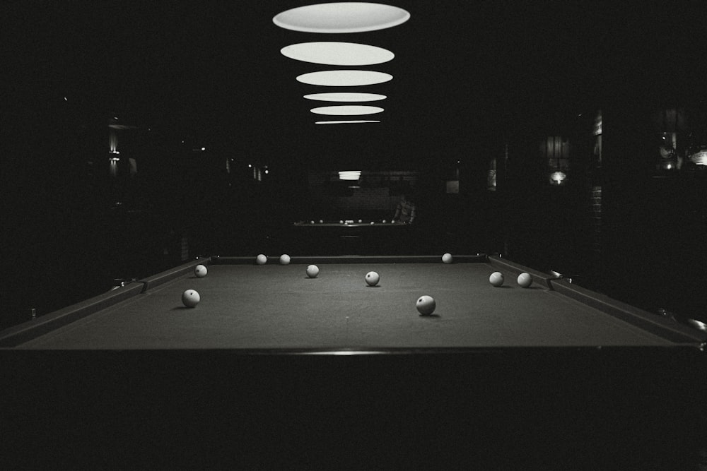 a black and white photo of a pool table