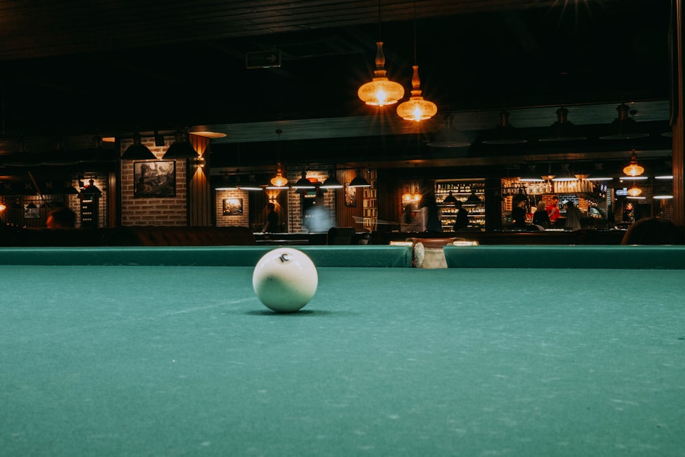 a pool table with a white ball on it